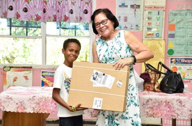First Lady, Mrs. Sandra Granger, donates a robotic kit to the students of Den Amstel Primary School in July 2018.