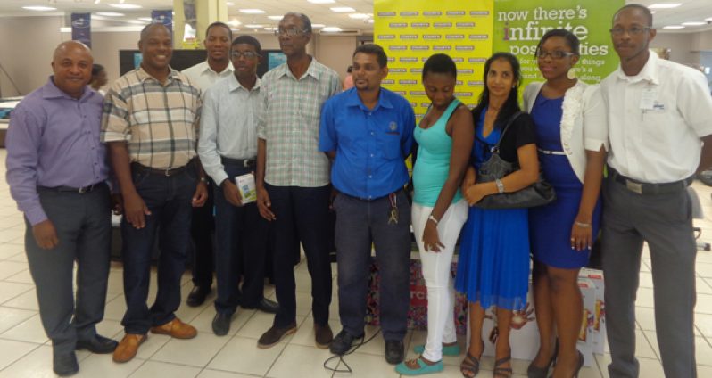 The winner of the “I love my appliances” promotion, Shazim Ali (centre), is flanked by the winners of the ‘Credit Promotion’ and the Courts Facebook Penalty Shootout Competition. Director of Credit, Kenneth Scrub is at right, while Marketing Manager Pernell Cummings is at left, and Marketing Officer/Public Relations and Promotions Officer, Roberta Ferguson, is second left.
