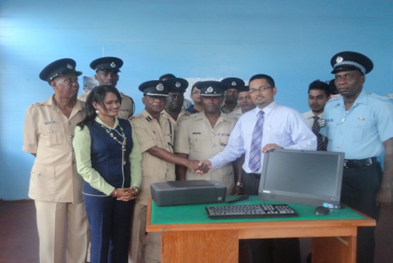 Manager of Republic Bank, Vreed-En-Hoop branch Mr. Shridath Patandin with Commander of ‘D’ Divison Mr. Eric Bassant after handing over the computer last Thursday.