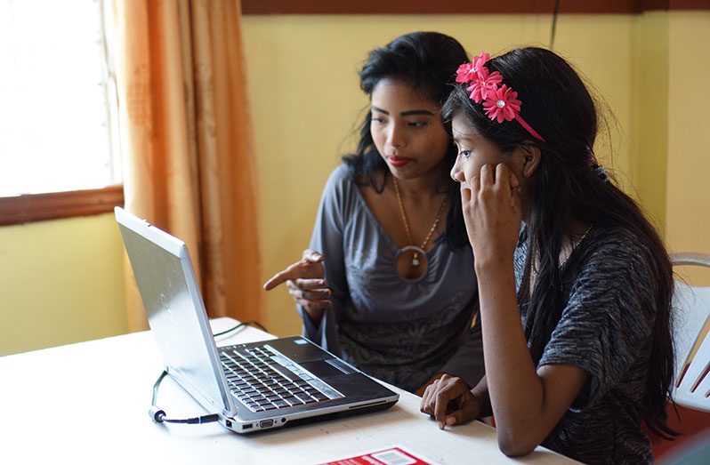 Schoolchildren at the NHS building making use of the computer and free internet access to do their on-line learning (Carl Croker photos)