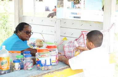Aunty Bootie tending to a schoolboy at her stand