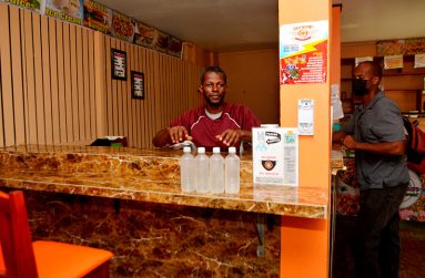 Wayne Williams displaying his local coconut water on sale (Carl Croker photos)