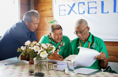 President David Granger (right) and Fourth Vice President and Minister of Indigenous Peoples’ Affairs, Mr. Sydney Allicock (centre), examine a document shown to them by a resident during a visit to Chinowieng Village, Cuyuni – Mazaruni (Region Seven) earlier this month.