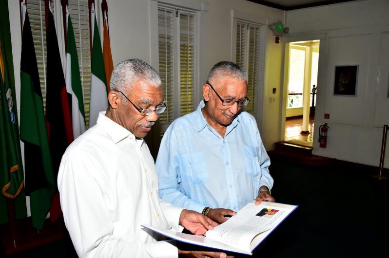 President David Granger getting a first glance of the page on which he is featured