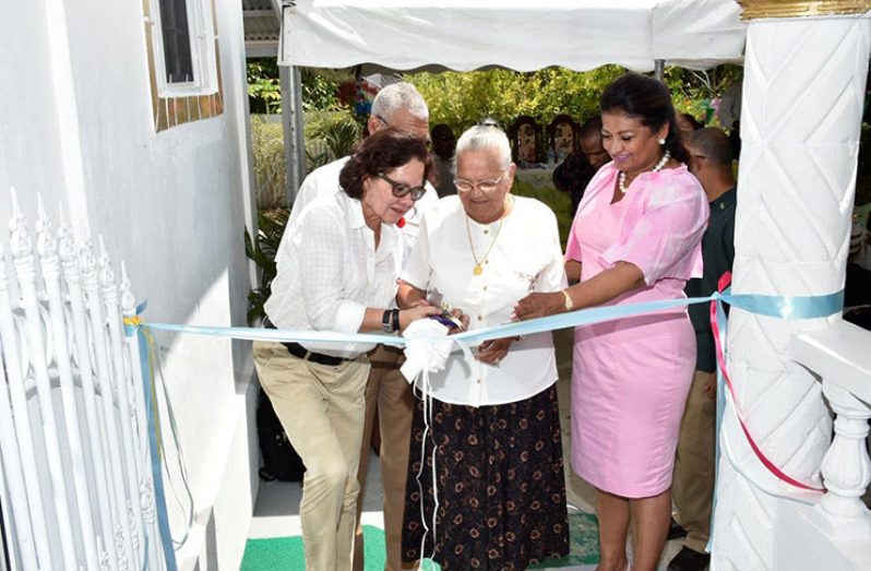President David Granger (partly hidden behind the First Lady), First Lady Sandra Granger and Mrs. Supriya Singh-Bodden help Mrs. Seraji Sankar to cut the ribbon to officially open the Guyana Foundation Sunrise Centre at Zorg-En-Vlygt, Essequibo Coast
 