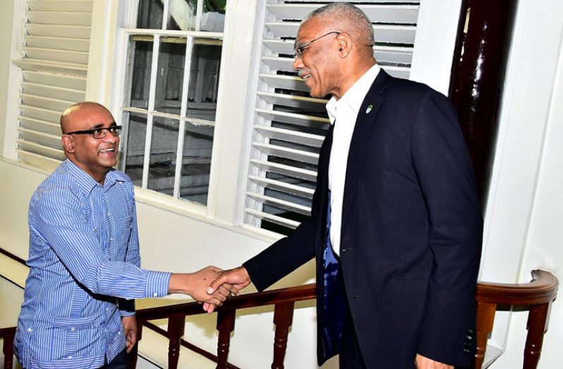 President David Granger greets Opposition Leader Bharrat Jagdeo on his arrival at State House on March 1