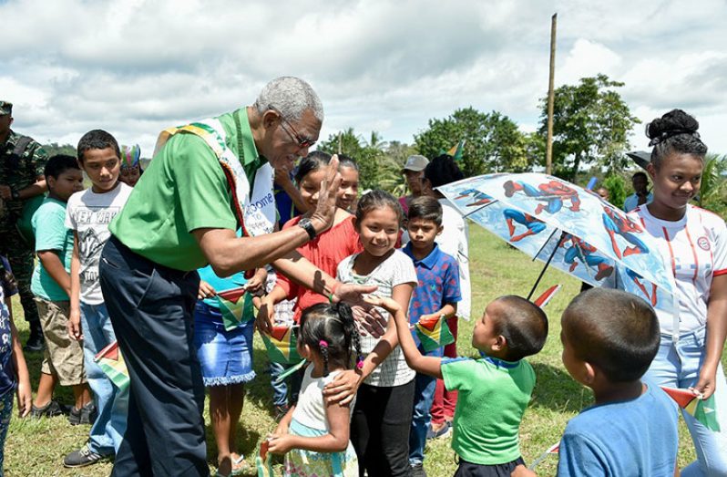 President David Granger cheerfully greeted this young lad in August 2019 as he arrived at a children’s welcome at Jawalla Village, Cuyuni-Mazaruni (Region Seven), for the Upper Mazaruni Games.