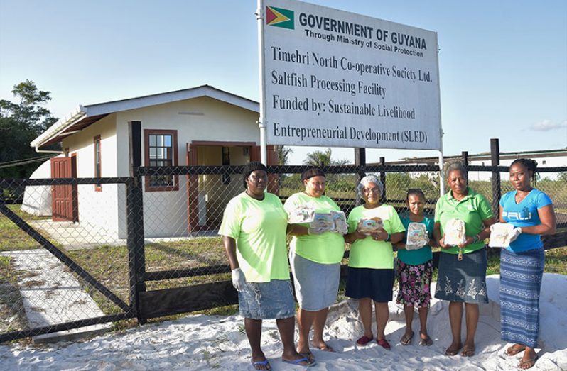 Chairperson of the Timehri North Cooperative Society, Ms. Carmen Simon (second from right) and other members of the cooperative display processed salted fish in front of the newly constructed salted fish-processing facility at Timehri North, East Bank Demerara