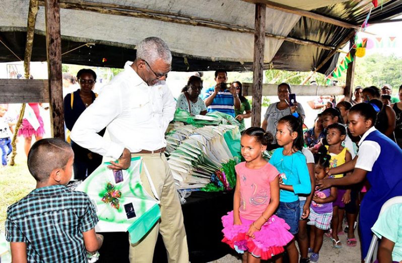 President Granger interacts jovially with one of the younger children from Murataro Village, Upper Demerara River