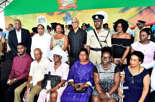 President David Granger, Prime Minister Moses Nagamootoo and Minister of State, Mr Joseph Harmon pose for a picture with Mr Brian Joseph and his family members