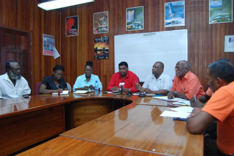 L-R Minister of Tourism (ag.) Irfaan Ali and Small Business Bureau CEO Derrick Cummings, with representatives from the United Minibus Union.
