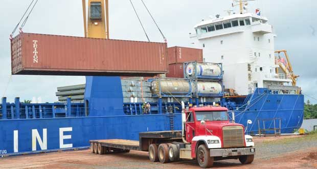 Parts of the mill being offloaded on Monday (Adrian Narine photo)