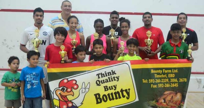 Tournament winner Jason-Ray Khalil (extreme left) strikes a pose with other winners of the Bounty Farm Mashramani Handicap Squash Tournament at the Georgetown Club Court last evening. Second right is the Squash Association president David Fernandes while at third from right is Regan Pollard. (Adrian Narine photo)