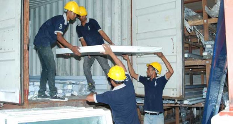 Some staff members loading the container for shipping to Grenada