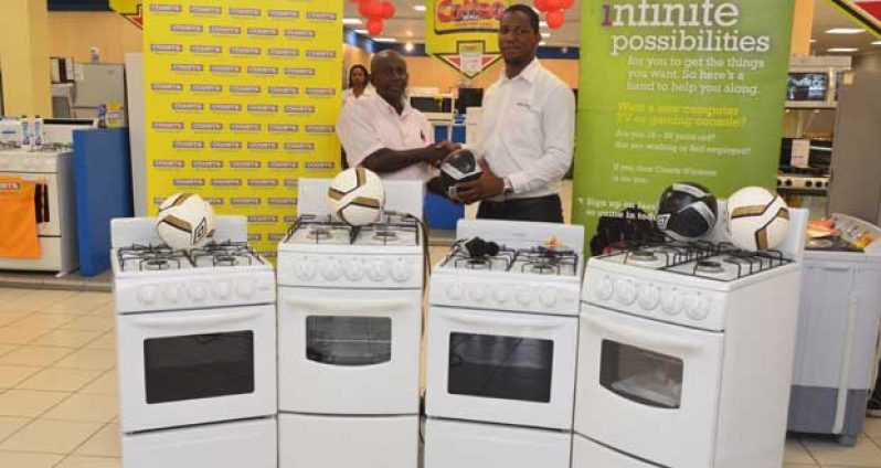 Buxton Youth Developers founder, Mr Robin Phillips (left) receiving the donated items from Courts Guyana’s Pernell Cummings