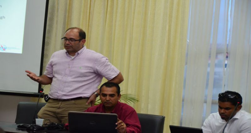 Dr Navarro makes a point during the public consultation. To his left is head of the NFMU, Valmiki Singh, and another NFMU staffer.