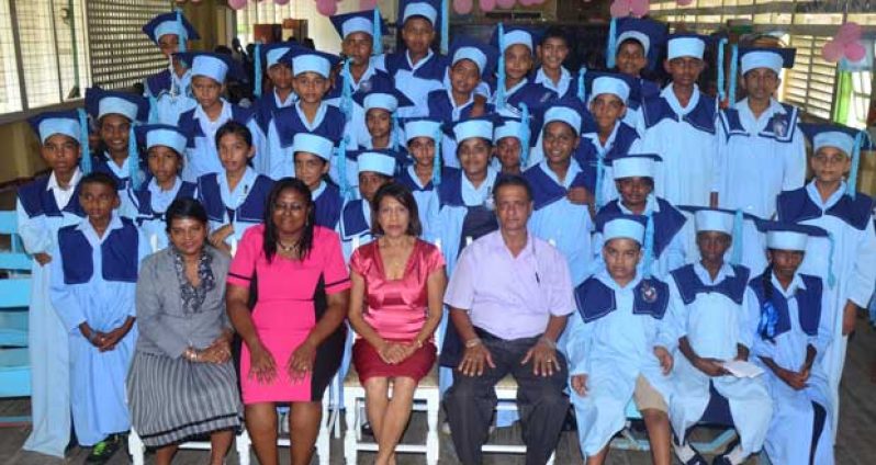 L-R Representative of the Ministry of Education Region #3; Headmitress of McGillivary Primary School Vashti Paul; First Lady Deolatchmee Ramotar; and Chairman of Region #3, Julius Faerber with the graduating class of 2014.