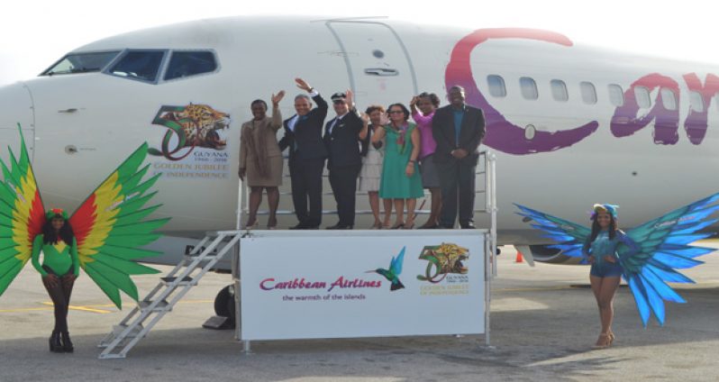 Onboard! The 50th Independence Anniversary Logo mounted on one of the Caribbean Airlines aircraft. In photo are from left: Minister within the Ministry of
Education, Nicolette Henry; Caribbean Airlines Chairman, Phillip Marshall; pilot of the aircraft, Andrew Wood; Minister within the Ministry of Indigenous People’s
Affairs Valerie Garrido-Lowe; First Lady Sandra Granger; and Ministers of Public Infrastructure, Annette Ferguson and David Patterson
(Cullen Bess-Nelson photo)