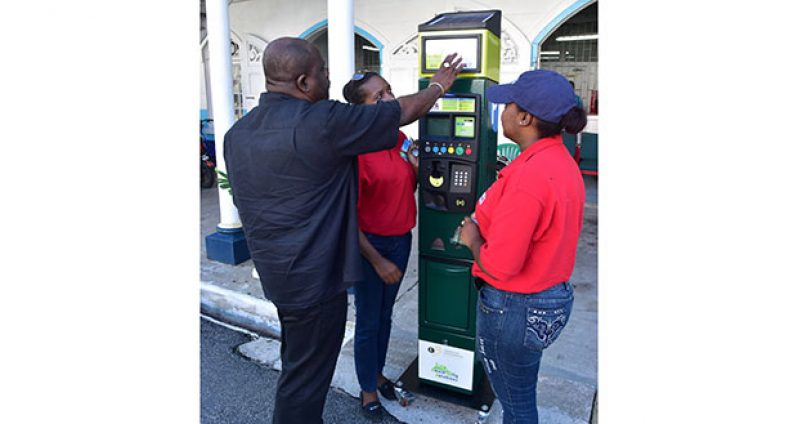 Town Clerk Royston King inspects one of the parking meters expected to be rolled out on September 1