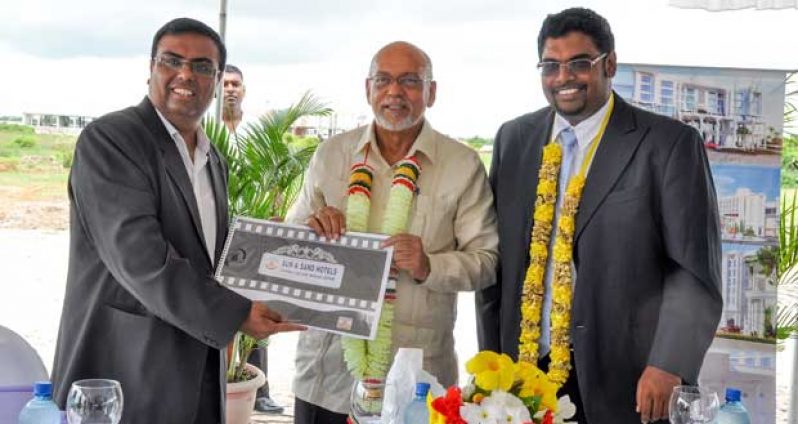 “Director of the Sun & Sand Group of Companies, Mr. Bushan Chandra (left) makes presentation to President Donald Ramotar and Minister of Tourism, Industry & Commerce (ag), Mr. Irfaan Ali. (Photo by Delano Williams)