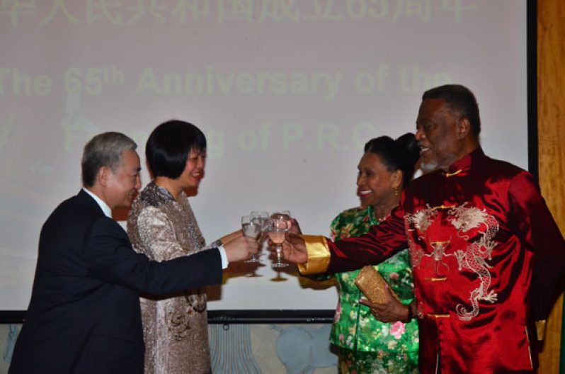 Chinese Ambassador Zhang Limin, the ambassador’s wife Liu Yiu, Mrs. Yvonne Hinds and Prime Minister and Acting President Samuel Hinds toasting at a function to mark the 65th anniversary of the founding of the People’s Republic of China