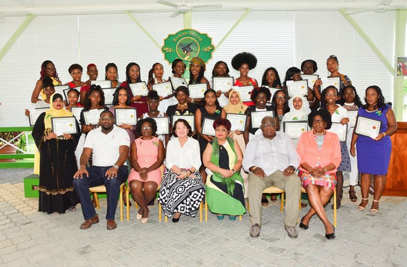 First Lady Sandra Granger (centre, left); Minster of Social Protection, Amna Ally (centre, right); Chairman of the Board of Industrial Training, Clinton Williams; Chief Facilitator of the Early Childhood Development workshop, Paulette Bollers and  Guyana Red Cross Society (GRCS) representative, Jevon Lewis, surrounded by  graduates of the  First Lady’s  Early Childhood Development Programme