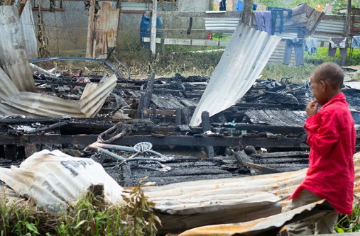 Eight-year-old Carlos Sampio cried yesterday as he stared at what’s left of the home he and his family shared