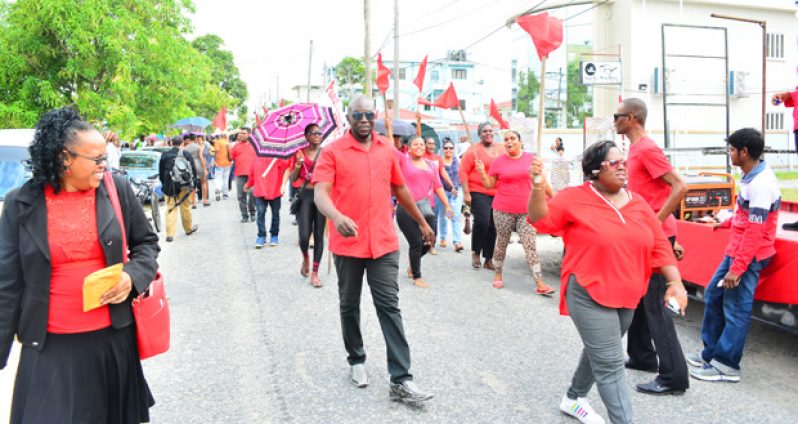 PPP supporters led by Gillian Burton-Persaud march on Waterloo Street after
submitting their lists of candidates yesterday