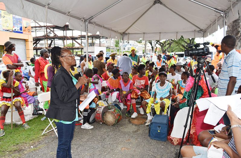 Festival Coordinator Ms. Linda Griffith addressing masqueraders at the launch yesterday on Main Street outside the Department of Culture, Youth and Sport