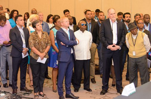DSC_0199 Minister of Foreign Affairs Carl Greenidge (in dark glasses) stands in the audience during the opening ceremony of the conference