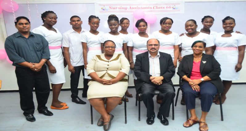 Nursing Assistants (standing) flanked by Minister of Health, Dr. Bheri Ramsaran (seated centre)with coordinators of the evening classes, Penelope Layne and Diane Murphy (Photos by Adrian Narine)