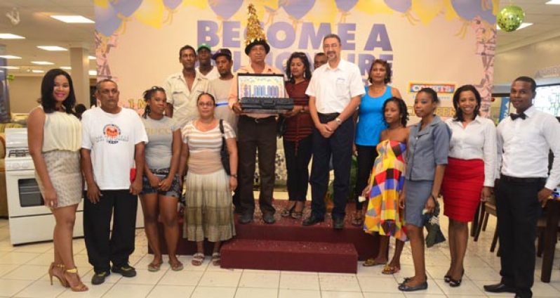 Courts Managing Director Clyde De Haas with the 12 winners of the ‘Become a Millionaire’ promotion and other participants