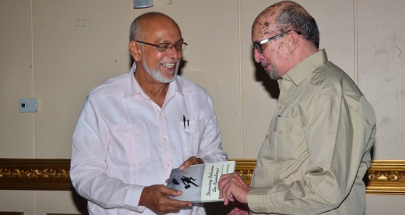 His Excellency President, Donald Ramotar receiving Dr. Rudy Insanally’s second book ‘Dancing between the Raindrops - A Dispatch from a Small State Diplomat’ at the book launch on Tuesday at the Pegasus Savannah Suite (Photo by Adrian Narine)
