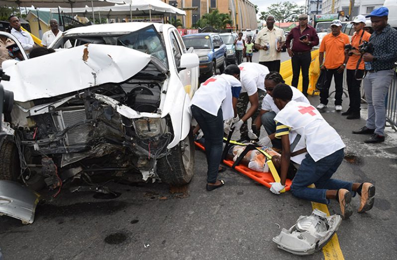 Members of the Guyana National Road Safety Council conducting a simulation exercise, showing how accidents are dealt with. [File photo]