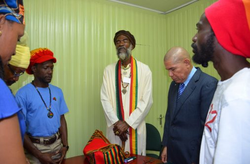 President of the Guyana Rastafarian Association, Ras Simeon, leads the group in prayer before the commencement of the meeting