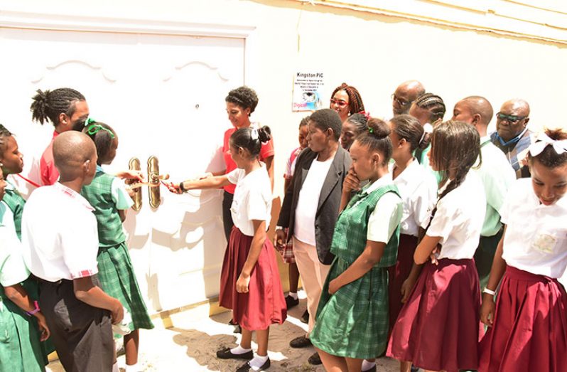 Queenstown Secondary student Priya Seepaul cutting the ribbon to the newly refurbished Kingston Practical Institute (KPI) yesterday