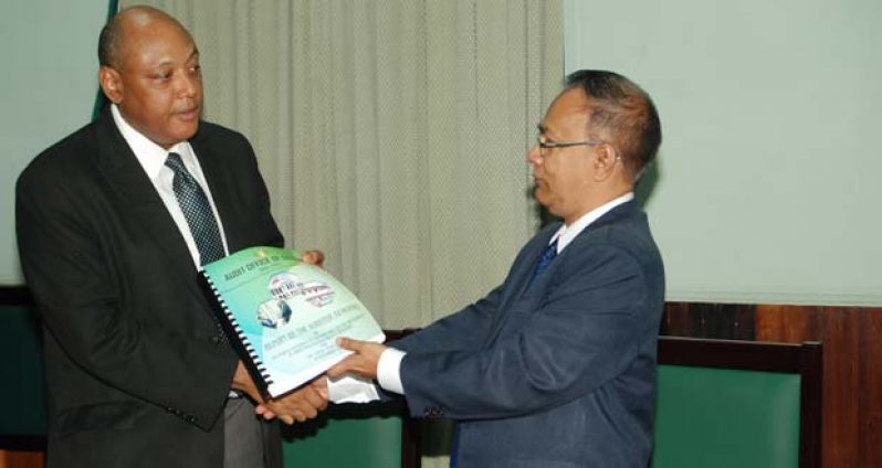 Speaker of the National Assembly, Mr. Raphael Trotman, accepts the 2013 audited report on Government’s accounts from the Auditor General, Mr. Deodat Sharma