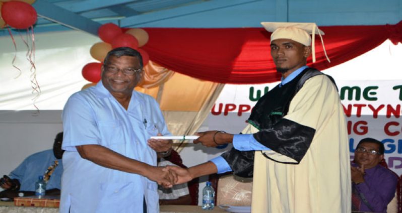 Dr Gopaul assisting in the distribution of certificates to the graduates