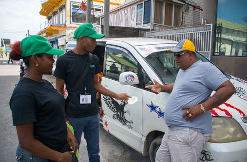 Staff of SCS yesterday explaining to one motorist on Camp Street why a sticker was placed on his windscreen