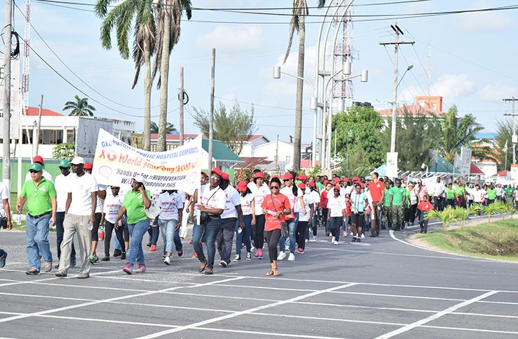 With a massive youth following, Public Health Minister Dr. George Norton (left) and the UNAIDS Representative (right) led the World AIDS Rally and March around Georgetown on Saturday