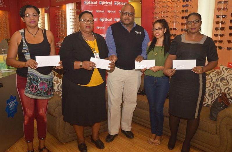 The winners posing with their letters, flanked by Courts Optical Brand Manager, Richard Simpson (at centre).