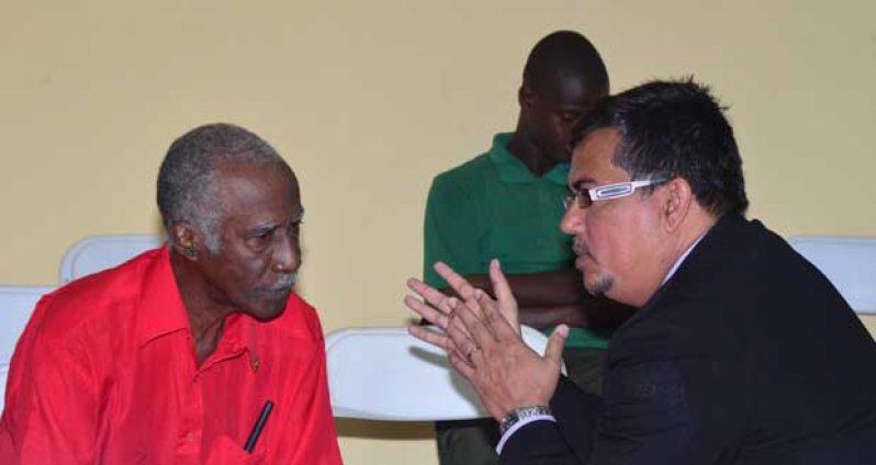 Lead Council in the Commission, Glen Hanoman (right), having a word with Mr. Lawrence Edward Rodney.
