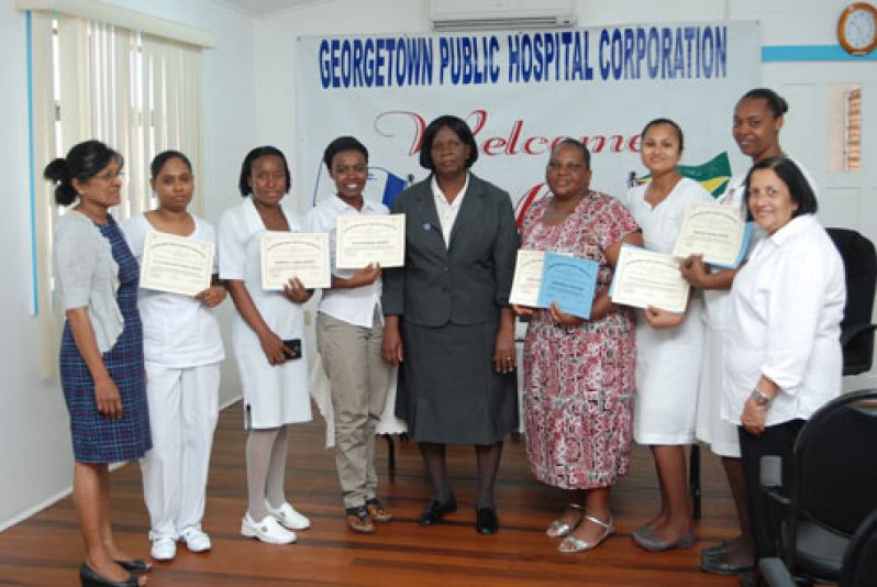 The nurses with their certificates in hand pose for a photograph with officials of the GPHC and the Caribbean North Charities Foundation (CNCF)