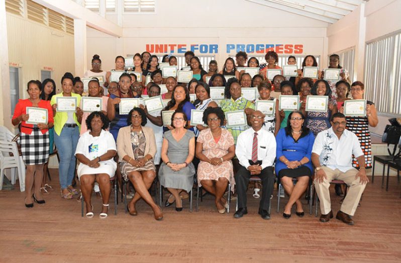 Forty -six women on Friday successfully completed the Self Reliance and Success in Business Workshop at Kildonan, East Berbice-Corentyne (Region Six).  Here they pose with their certificates. Seated are (l-r) – Ms. Barbara Pilgrim, Lt. Col. (ret’d) Ms Yvonne Smith, First Lady, Mrs Sandra Granger, Deputy Director of the University of Guyana, Berbice Campus and Chairperson of the Lands and Survey Committee, Mrs Paulette Henry, Director of Interweave Solutions Incorporated, Mr Wayne Barrow, Regional Executive Officer of Region Six, Ms. Kim Williams Stephen and Regional Chairman of Region Six, Mr David Armogan