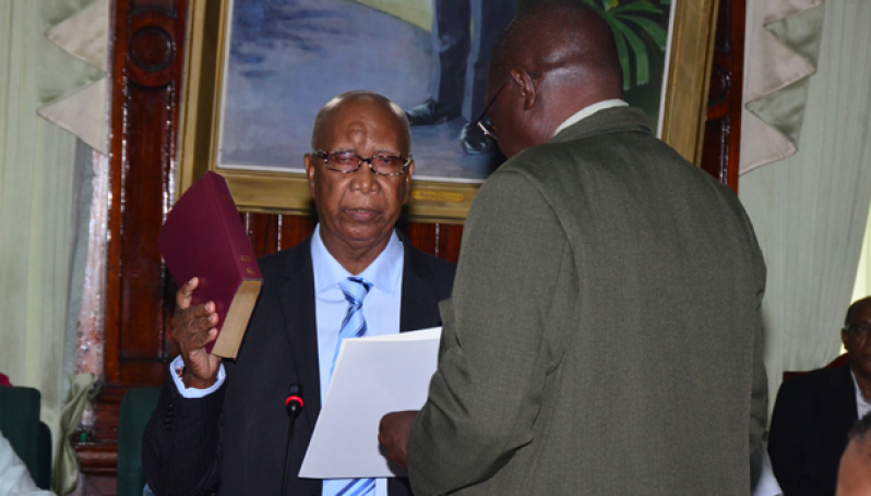 New MP Ernest Elliot is sworn in by Clerk Sherlock Isaacs