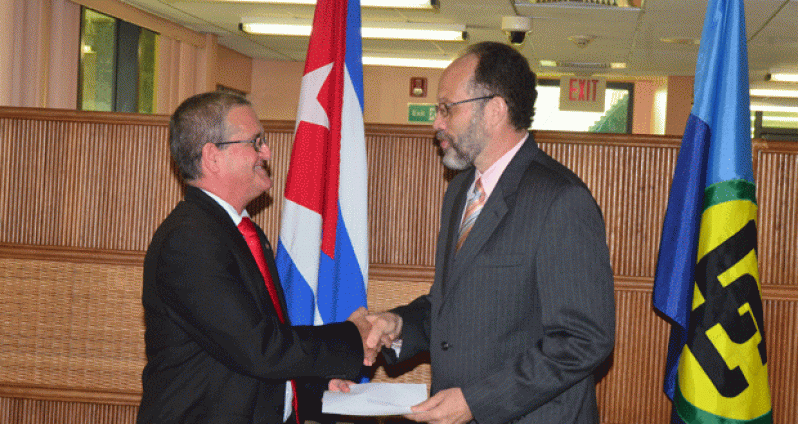 His Excellency Mr Julio Cesar Gonzalez Marchante, Plenipotentiary Representative of Cuba to CARICOM presents his credentials to the CARICOM Secretary General, Ambassador Irwin LaRocque.