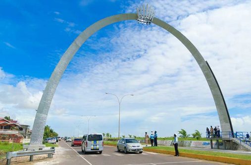 Officials of AnsaMcal share a moment at the bottom of the arch.