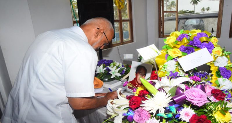 President Donald Ramotar signing the Book of Condolence yesterday for the late Mr David de Groot at the Memorial Gardens Crematorium, where a Thanksgiving Service was held before he was cremated