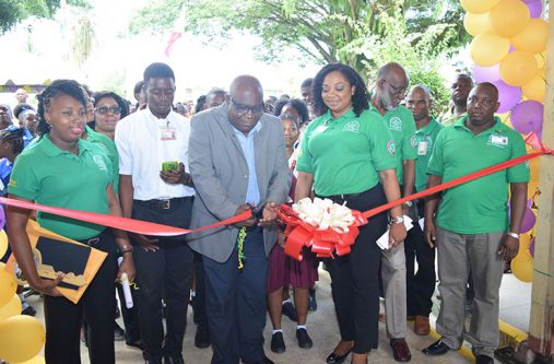 DSC_0522 Assistant Chief Education Officer, Patrick Chinedu, cuts the ribbon to declare open the Trade of Trades exhibition at the Government Technical Institute as Chairman of the Board of Governors, Vincent Alexander and other GTI executives, students and teachers, look on