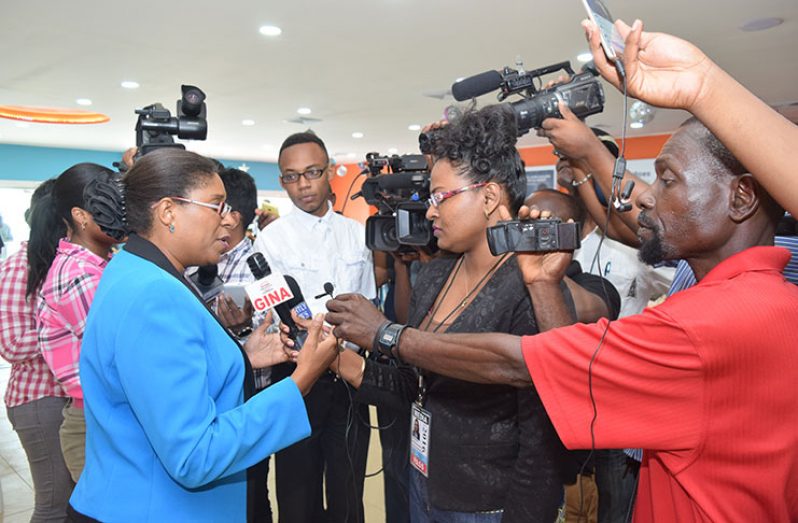 Minister of Public Telecommunications Cathy Hughes speaking to reporters on Friday